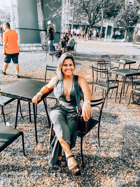 Smiling woman in a comfortable seated pose outdoors